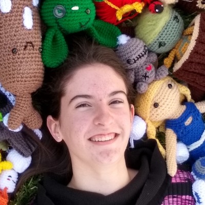 Josephine Stockton at age fourteen surrounded by her handmade crochet animals