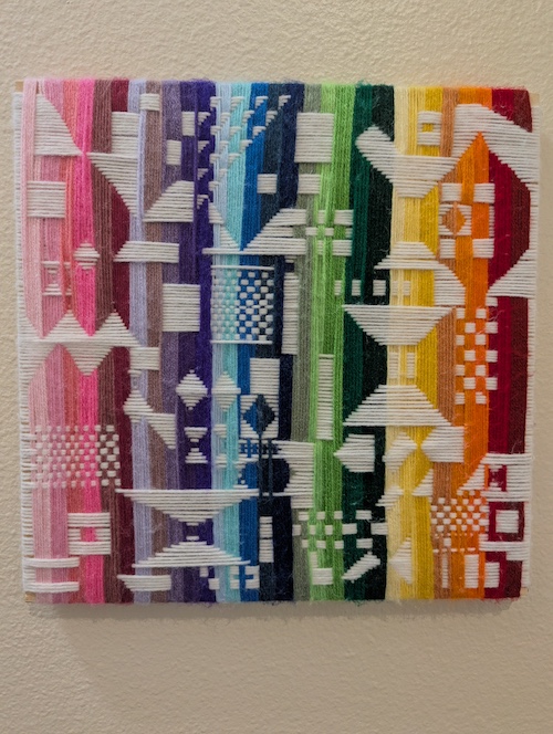 A colorful abstract woven fiber work